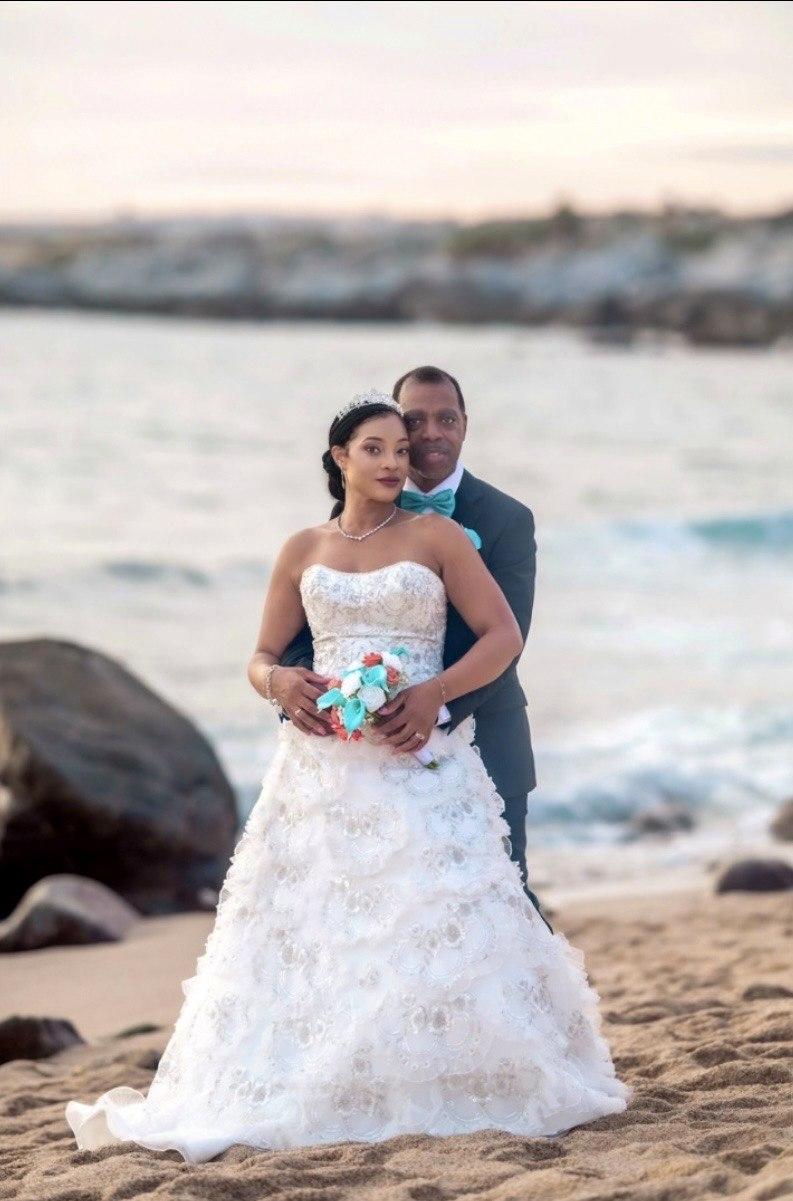 Bride and groom portrait along the shoreline at sunset