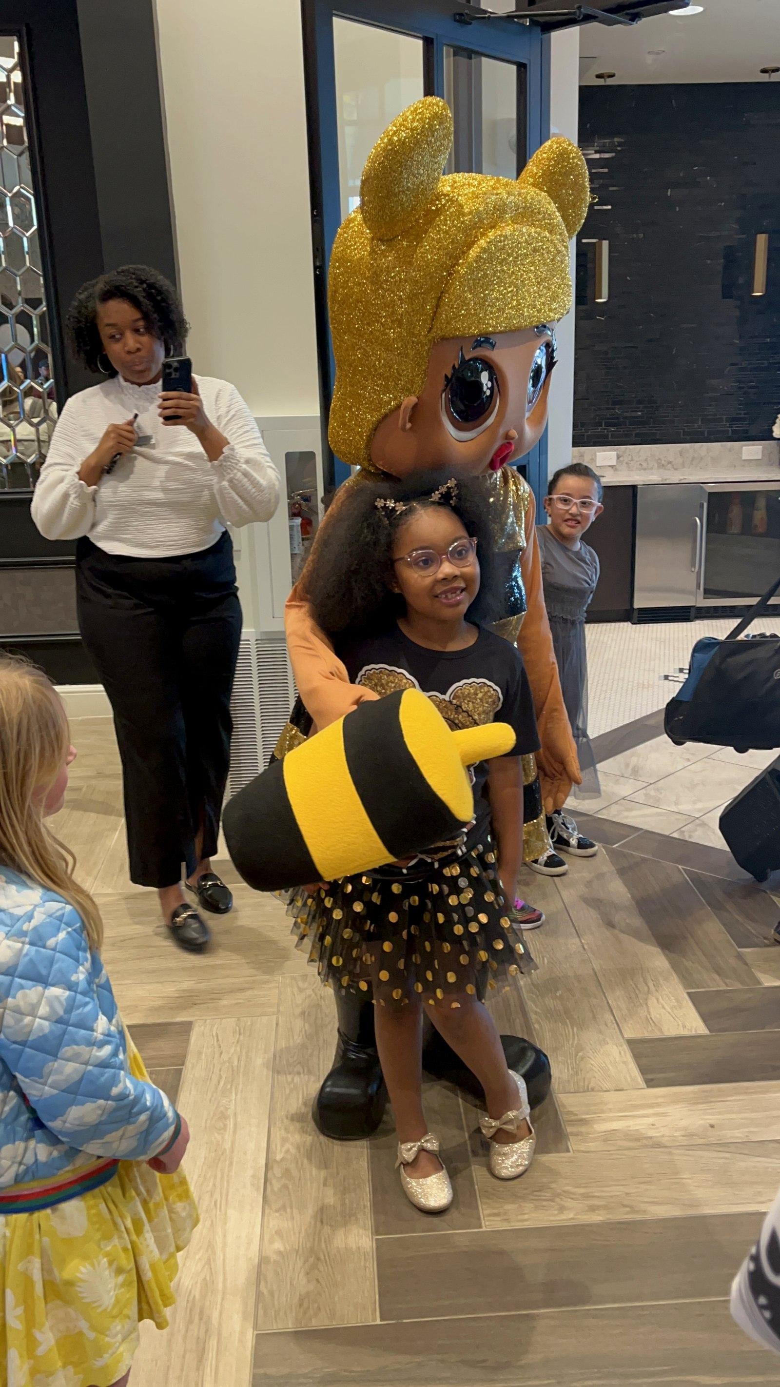 A surprise character mascot appearance delighting the birthday girl and guests