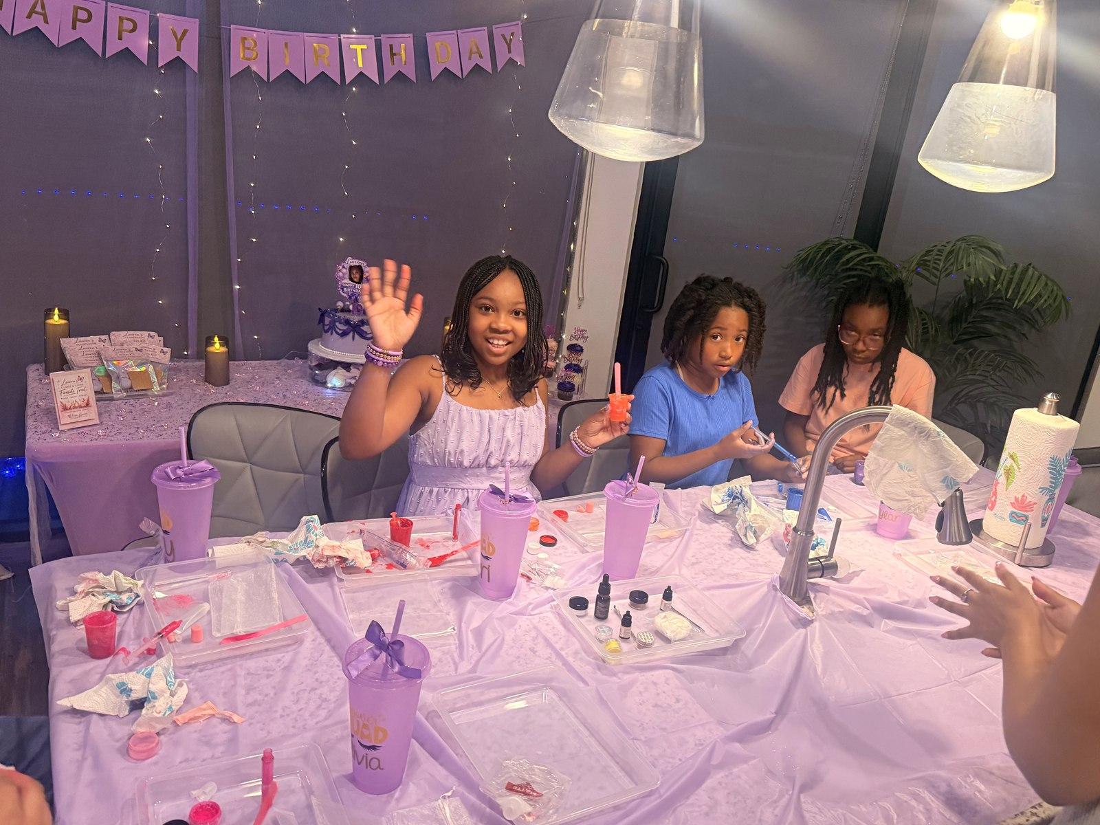 Guests creating custom lip gloss together at a lip gloss lab activity station