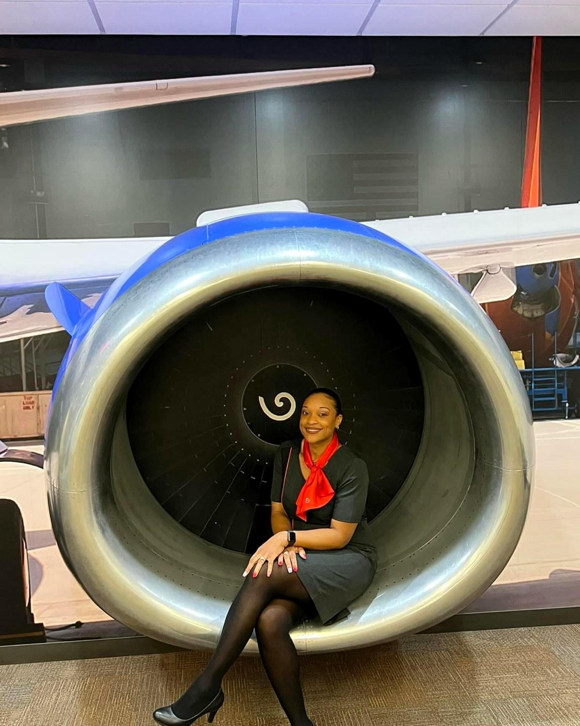 Juline of Fly Girl Events & Design seated within a jet engine