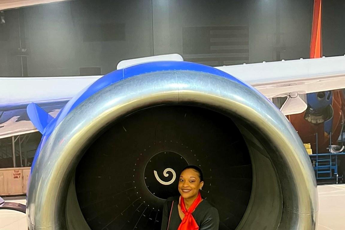 Juline of Fly Girl Events & Design seated within a jet engine